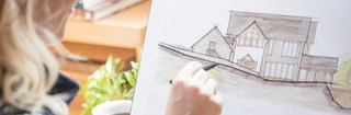 a person drawing a home