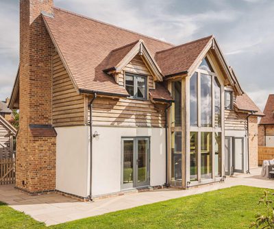 Oak frame house with double height glazed gable