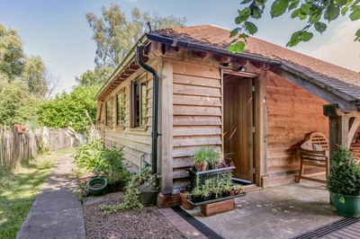 Oak frame garden barn with flowers