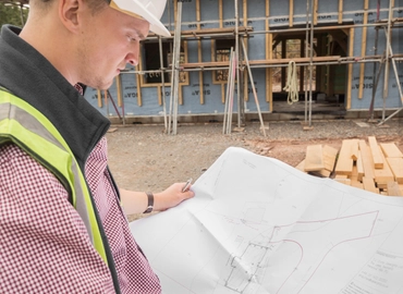 construction worker looking at plans