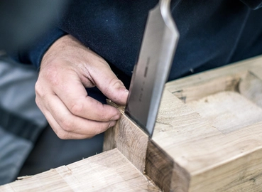 oak frame being chiseled