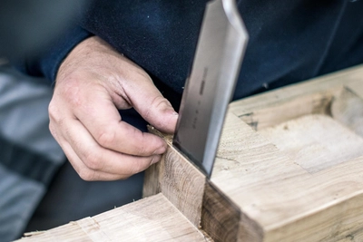oak frame being chiseled