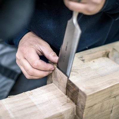oak frame being chiseled